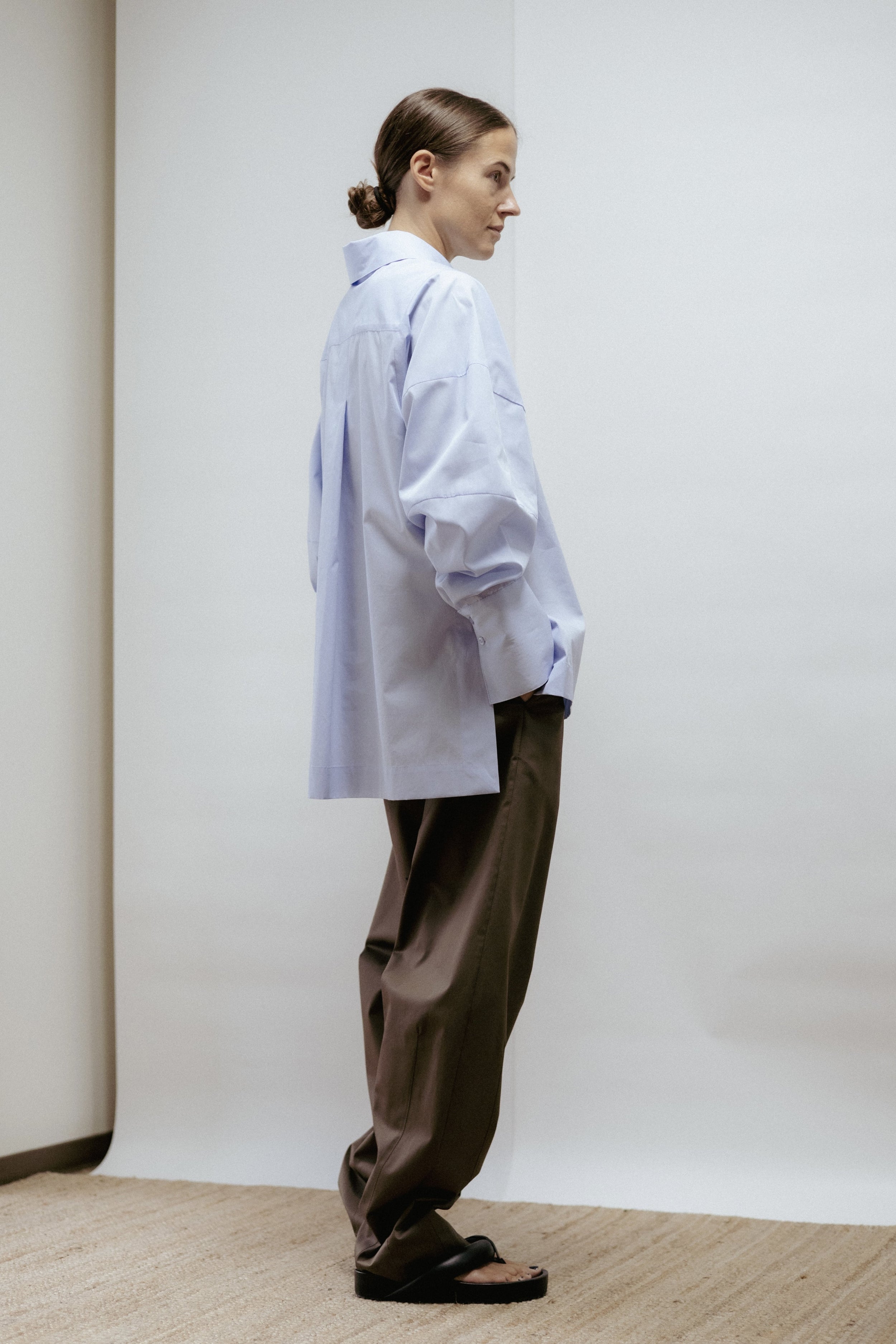 Light blue 100% cotton blouse with wide cuffs and sculptural sleeves. A minimalist design made in Estonia — refined, versatile, and designed to last.