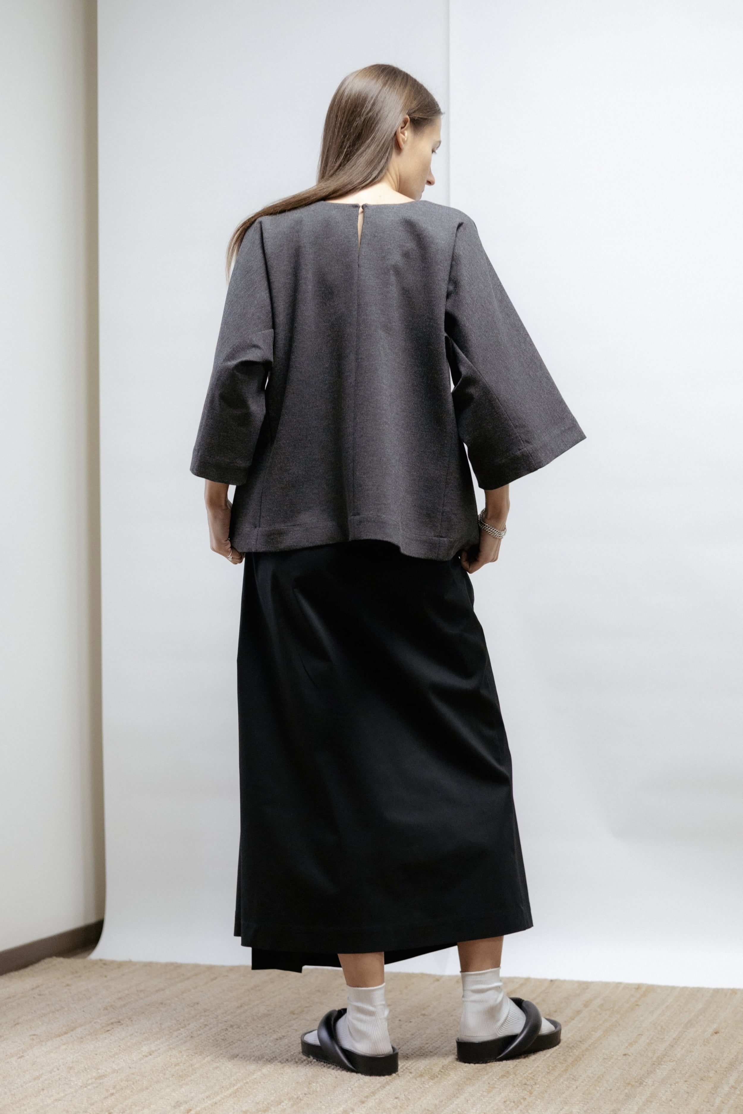 Dark grey jersey blouse with wide sleeves and round neckline. Relaxed fit and soft structure. Made in Estonia, timeless and versatile.