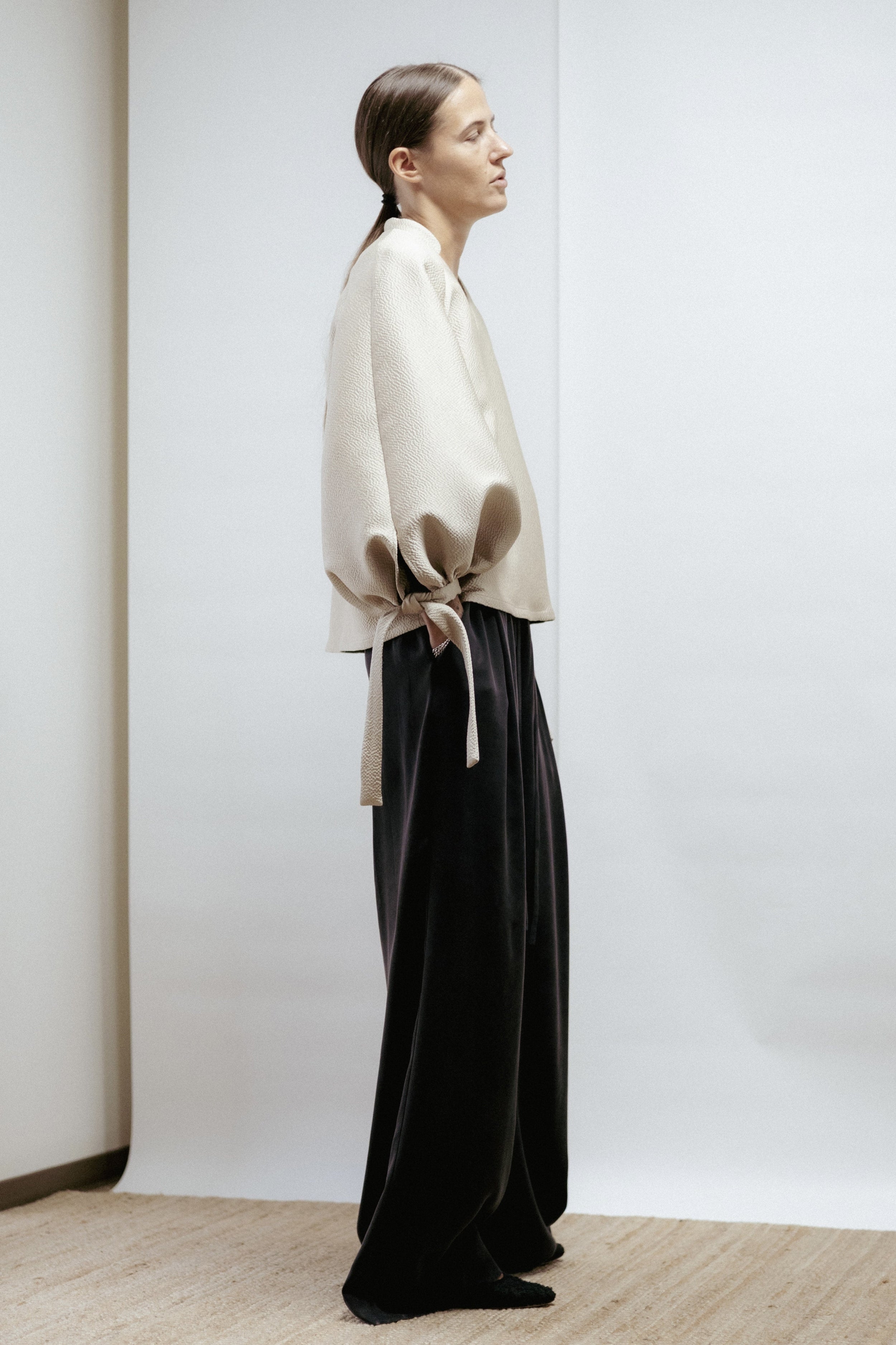 Light gold textured blouse with puff sleeves and V-neck. Elegant A-line silhouette, non-creasing fabric, made in Estonia.