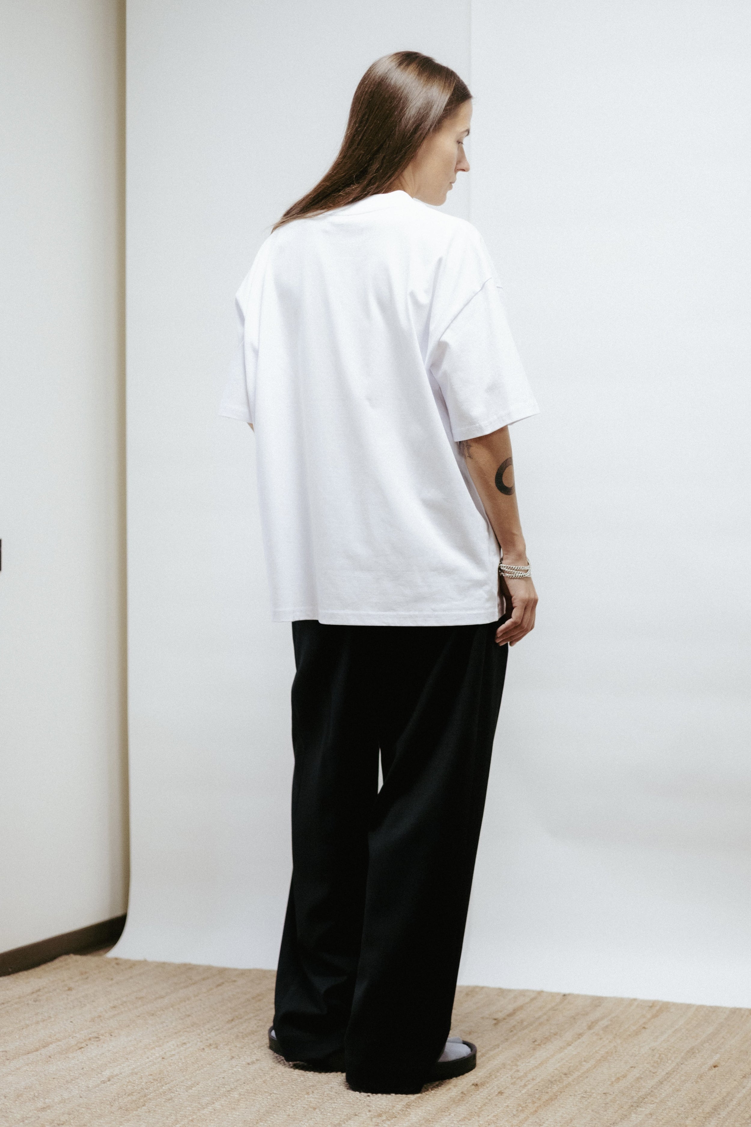 White unisex t-shirt in organic cotton with “Disco” print by Toomas Pääsuke. Relaxed fit, made in Estonia. Minimal, artistic, and timeless.