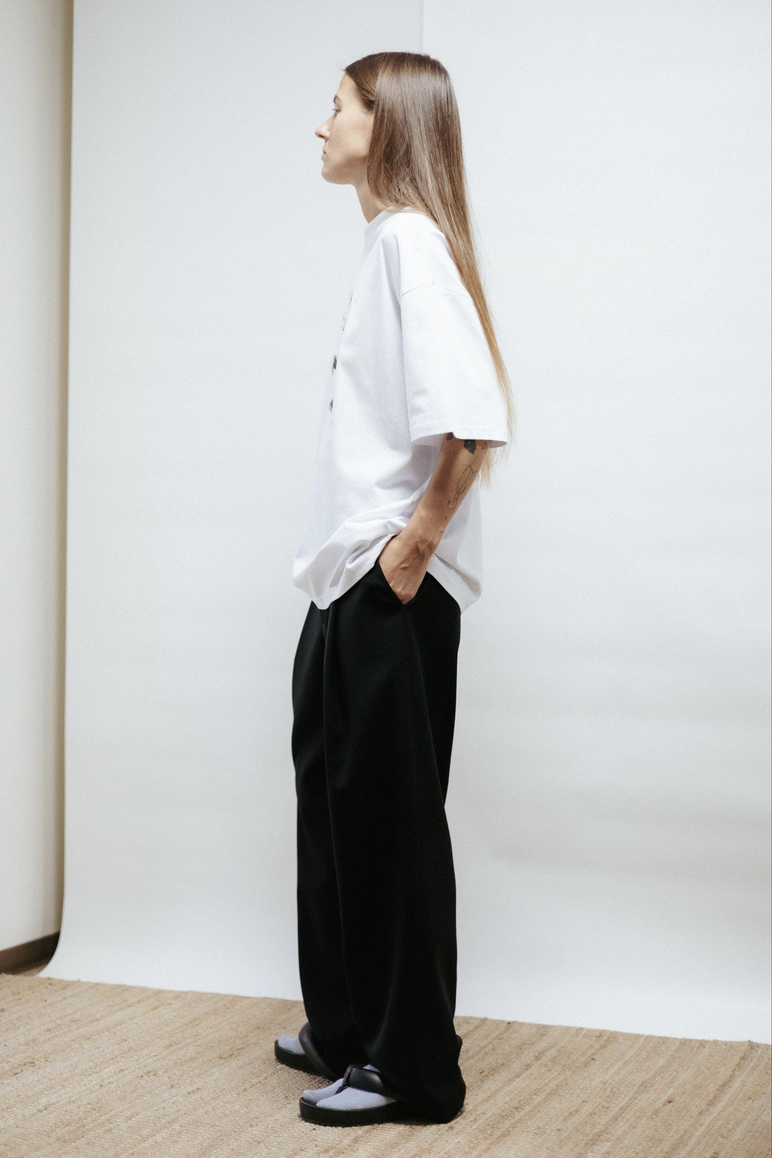 White unisex t-shirt in organic cotton with “Disco” print by Toomas Pääsuke. Relaxed fit, made in Estonia. Minimal, artistic, and timeless.