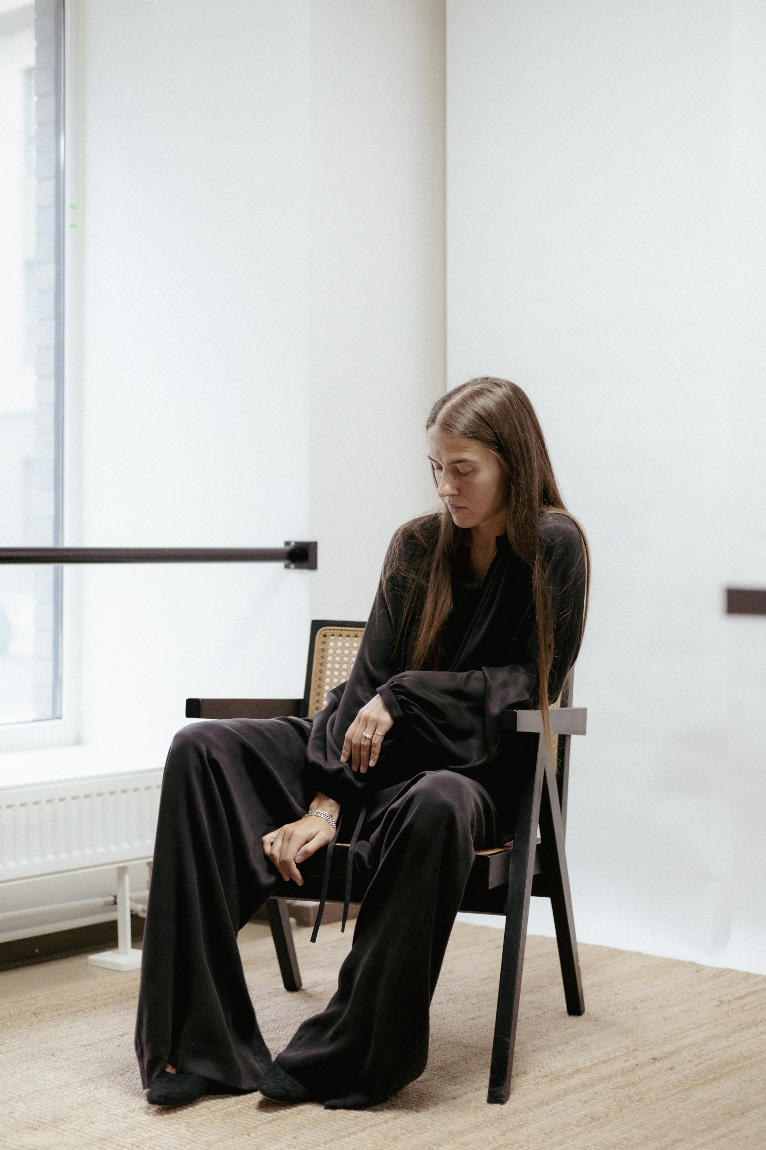 Wide black cupro trousers with elastic waist and drawstring. Soft drape, subtle sheen, and timeless elegance. Made in Estonia.