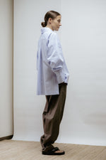 Khaki cotton barrel-leg trousers with mid-rise waist and subtle taper. Smart, effortless design made in Estonia.
