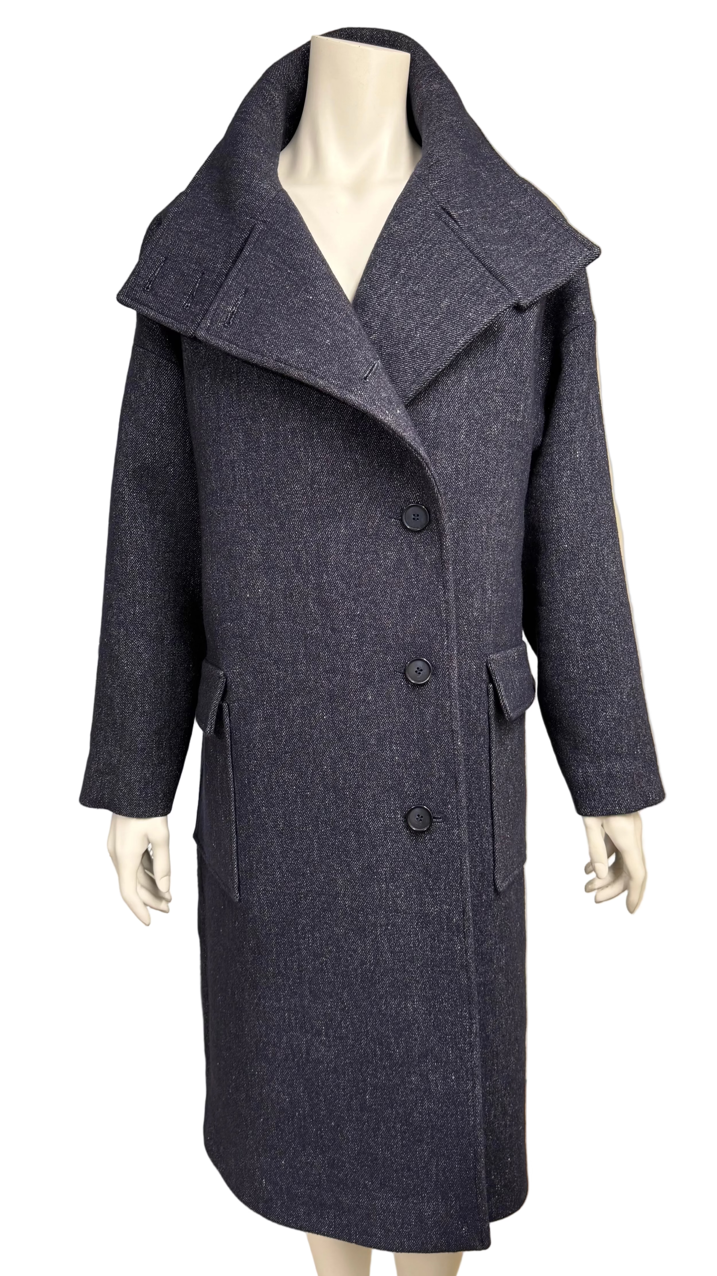 A dark navy blue textured wool coat with a wide collar and three front buttons, displayed on a mannequin in an indoor showroom setting.