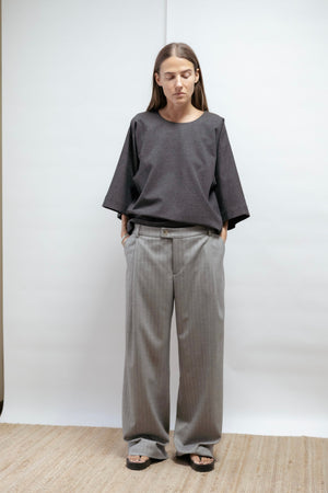 Grey herringbone wide-leg trousers in a soft viscose blend. Washable, non-creasing, and elegantly relaxed. Made in Estonia.