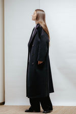 Dark grey wool coat with a wide lapel collar and slanted pockets. Straight, relaxed fit with back vent and light lining. Made in Estonia.