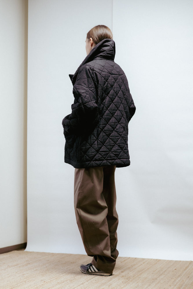 Quilted denim jacket with a straight, relaxed fit. Warmly padded with a high collar and large patch pockets. Made in Estonia.